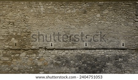 Very old brick stone wall of castle or fortress of 18th century. Full frame wall with obsolete dirty and cracked bricks close up