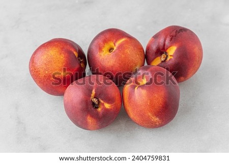 ripe sweet nectarines on a white marble surface close up shallow depth of field