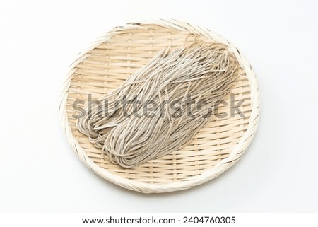 Raw soba noodles on a white background.
