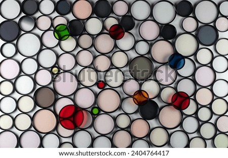 Glass round filters of different colors and sizes are isolated on a 
light background.