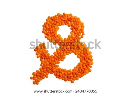 Symbol 'ampersand' formed from red lentil grains against a clean white backdrop. Harmonious blend of organic elements and typography, for food blog Royalty-Free Stock Photo #2404770055