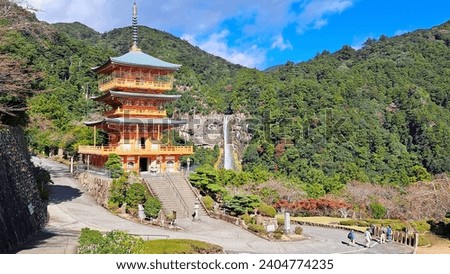 Three-story pagoda of Seiganto-ji, Three-story pagoda of Seiganto-ji with Nachi Falls in the background can make a good picture.  Royalty-Free Stock Photo #2404774235