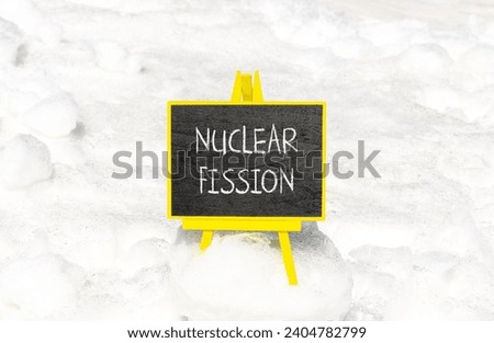 Nuclear fission symbol. Concept words Nuclear fission on beautiful black chalk blackboard. Chalkboard. Beautiful snow background. Business science nuclear fission concept. Copy space. Royalty-Free Stock Photo #2404782799