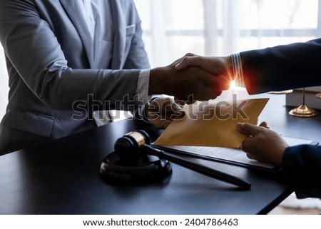 Businessman shaking hands thankfully closing a deal with his lawyer to discuss contract terms Good cooperation in counseling between lawyers, close-up photo