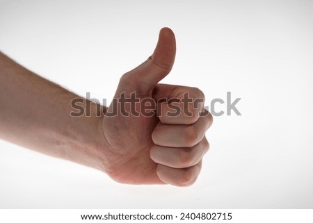 Close-up of caucasian male teenager hand doing thumb up sign. Photo taken December 25th, 2023, Zurich, Switzerland.