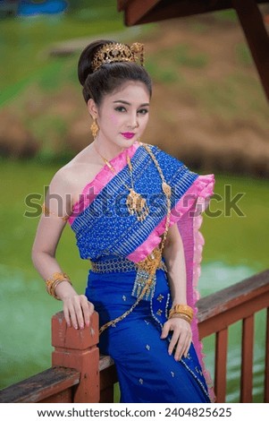 Portrait of asian woman wear ancient thai dress style,Thailand people Thai traditional dress pay respect Royalty-Free Stock Photo #2404825625