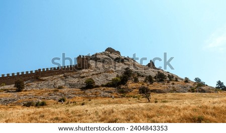 On the walls of Sudak Fortress, a glimpse into Crimea's historical might and architectural grandeur. Royalty-Free Stock Photo #2404843353