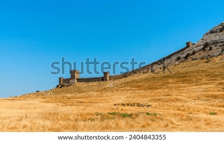 On the walls of Sudak Fortress, a glimpse into Crimea's historical might and architectural grandeur. Royalty-Free Stock Photo #2404843355