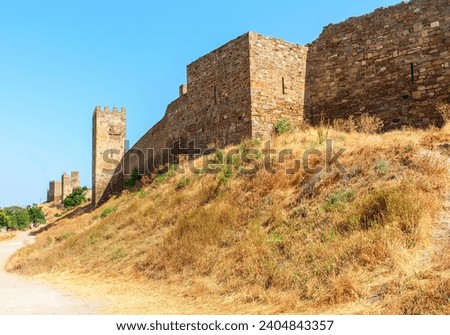 On the walls of Sudak Fortress, a glimpse into Crimea's historical might and architectural grandeur. Royalty-Free Stock Photo #2404843357