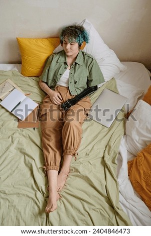 Girl Relaxing on Bed and Listening to Music