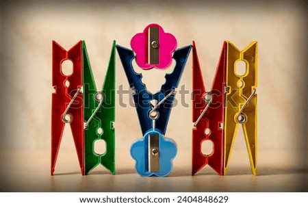An abstract photograph showing a collection of colourful cloth pegs and pencil sharpeners, photographed with a Macro lens.