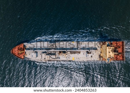 Top down view of Cement carrier vessel in transit in sea, global trade and maritime shipping. Aerial shot