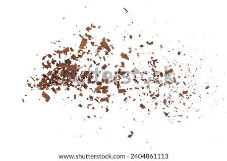 Pile scraped, milled dark chocolate shavings, 70 percent cocoa, isolated on white, top view  Royalty-Free Stock Photo #2404861113