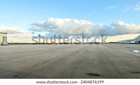 A large open parking space on an airport. Royalty-Free Stock Photo #2404876199