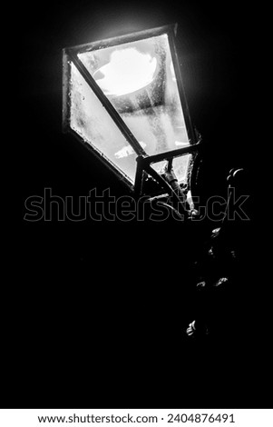 An old Victorian lamppost that still lights the streets in modern days  nights. Royalty-Free Stock Photo #2404876491