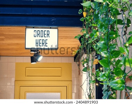 Order here sign retail stock photo
