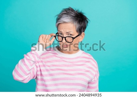 Photo of unsure suspicious lady wear striped sweater hand arm spectacles looking you isolated turquoise color background Royalty-Free Stock Photo #2404894935