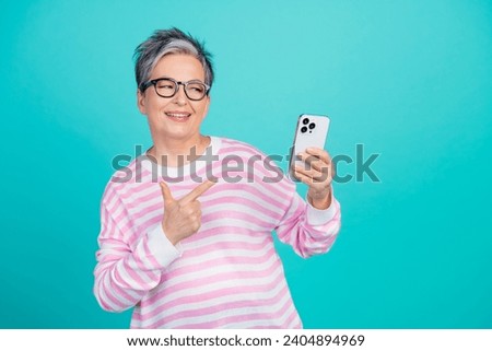 Photo of funky dreamy woman dressed pink pullover showing finger modern gadget empty space isolated teal color background