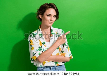 Photo of lovely cute girl dressed stylish summer clothes demonstrate empty space special news isolated on green color background