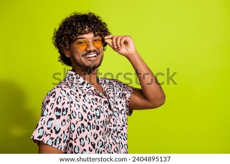 Photo portrait of handsome young guy touch sunglass toothy smile wear trendy pink leopard print outfit isolated on yellow color background
