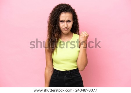 Young hispanic woman isolated on pink background with unhappy expression