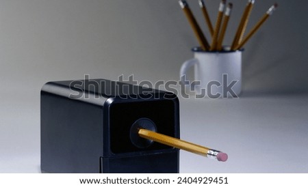 A pencil is a writing and drawing instrument consisting of a thin cylindrical graphite or colored core encased in a wooden or plastic barrel