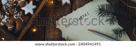 Banner. Christmas written letter with wish list with Dear Santa text. Xmas December tradition for kids and adults, cozy home decor, homemade gingerbread cookies, new year decoration, wooden background