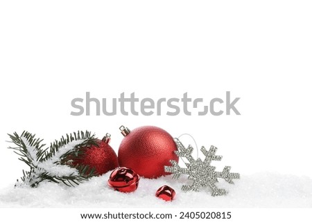 Beautiful red Christmas balls, fir tree branch and other festive decor on snow against white background
