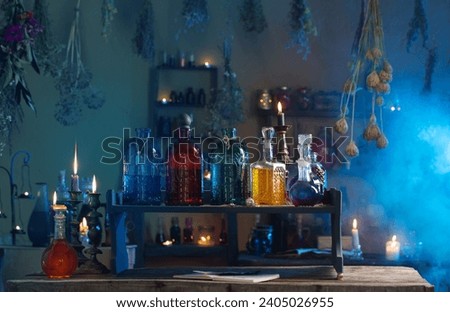 magic potions in  witch's house with burning candles at night Royalty-Free Stock Photo #2405026955