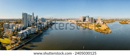 Aerial cityscape of Rhodes and Wentworth point urban high-rise aparment building suburbs on Parramatta river in Sydney West. Royalty-Free Stock Photo #2405030125