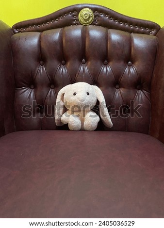 Little pink doll on red chair