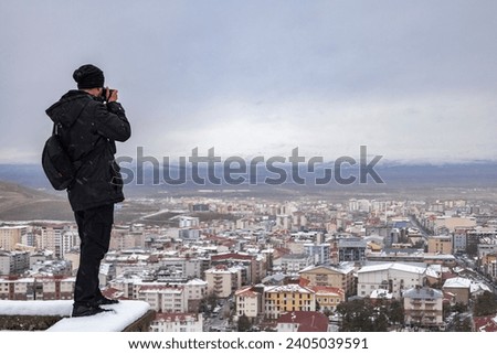 Nature photographer shooting in winter landscape