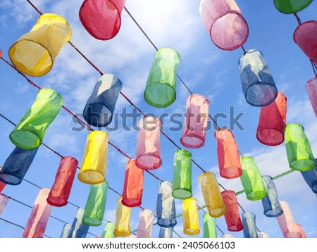 Colorful lanterns made from colored paper to decorate festivals or places on a beautiful blue sky background.