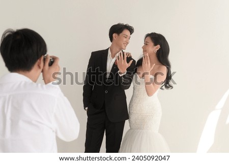 Photographer taking pictures of bride and groom in wedding ceremony, Love ,Romantic and wedding proposal concept.