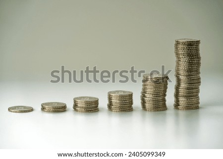 Scenic close-up view of piles of stapled gray metal five Swiss francs coins against white background. Photo taken December 26th, 2023, Zurich, Switzerland.