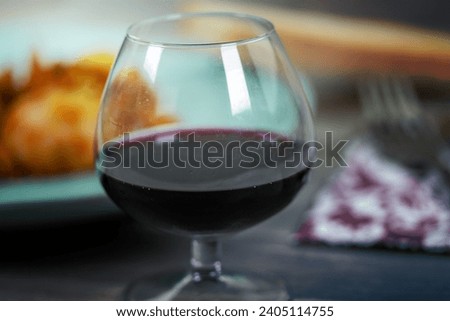 cuttlefish with peas and detail of red wine glass