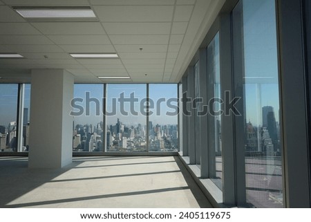 A modern interior with big panoramic window. Through glass view backgroun