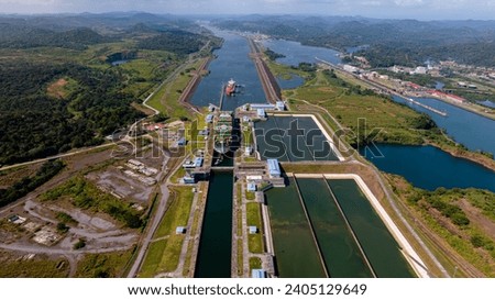 Aerial view Panama Canal, third set of locks, water shortages, maritime traffic, water reuse vats, summer drought. Royalty-Free Stock Photo #2405129649