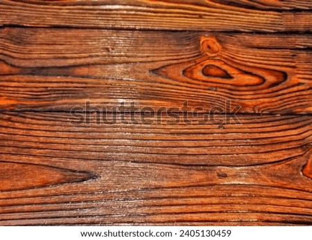 Picture of dark brown wood surface darkened by fire torched and polished