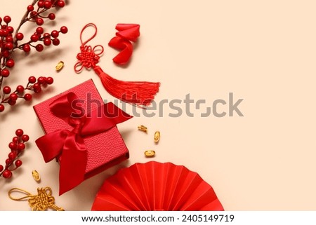 Gift box with fortune cookies and Chinese symbols on beige background. New Year celebration