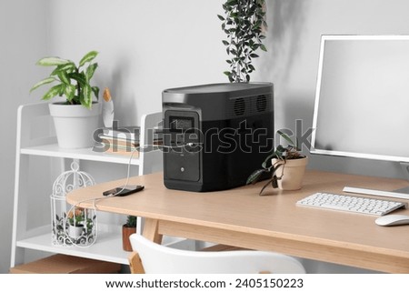 Comfortable workspace with modern computer and portable power station Royalty-Free Stock Photo #2405150223