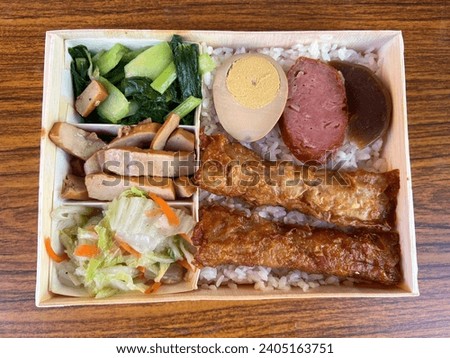 Taking a photo of the delicious shrimp roll bento for lunch