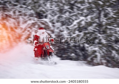 Cool Santa Claus biker or Frost Father riding on fast snow bike, motorcycle with ski background snow forest, sun light. Concept delivering Christmas gifts.