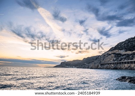 Amazing panoramic landscape of rocky shore photo. Sunrise sundown sky background with colorful clouds. Mediterranean sea. Beach concept photo. Bright seaside dusk. High quality picture for wallpaper