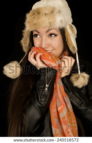 Asian American teen snuggling warm winter scarf