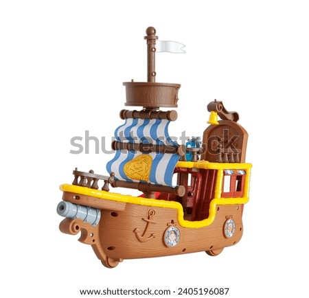 Toy pirate sailing ship with cannon on a white background
