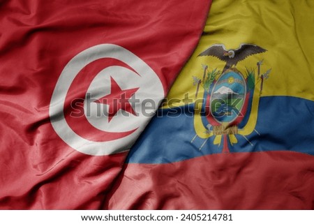 big waving national colorful flag of ecuador and national flag of tunisia . macro