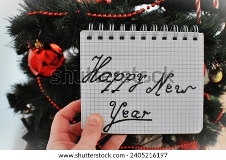 happy new year write next to christmas tree