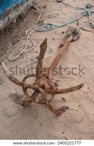 A weathered anchor, its iron etched with stories of the sea
