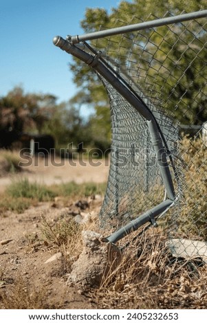 A vehicle ran into a fence post and damaged a fence. Royalty-Free Stock Photo #2405232653